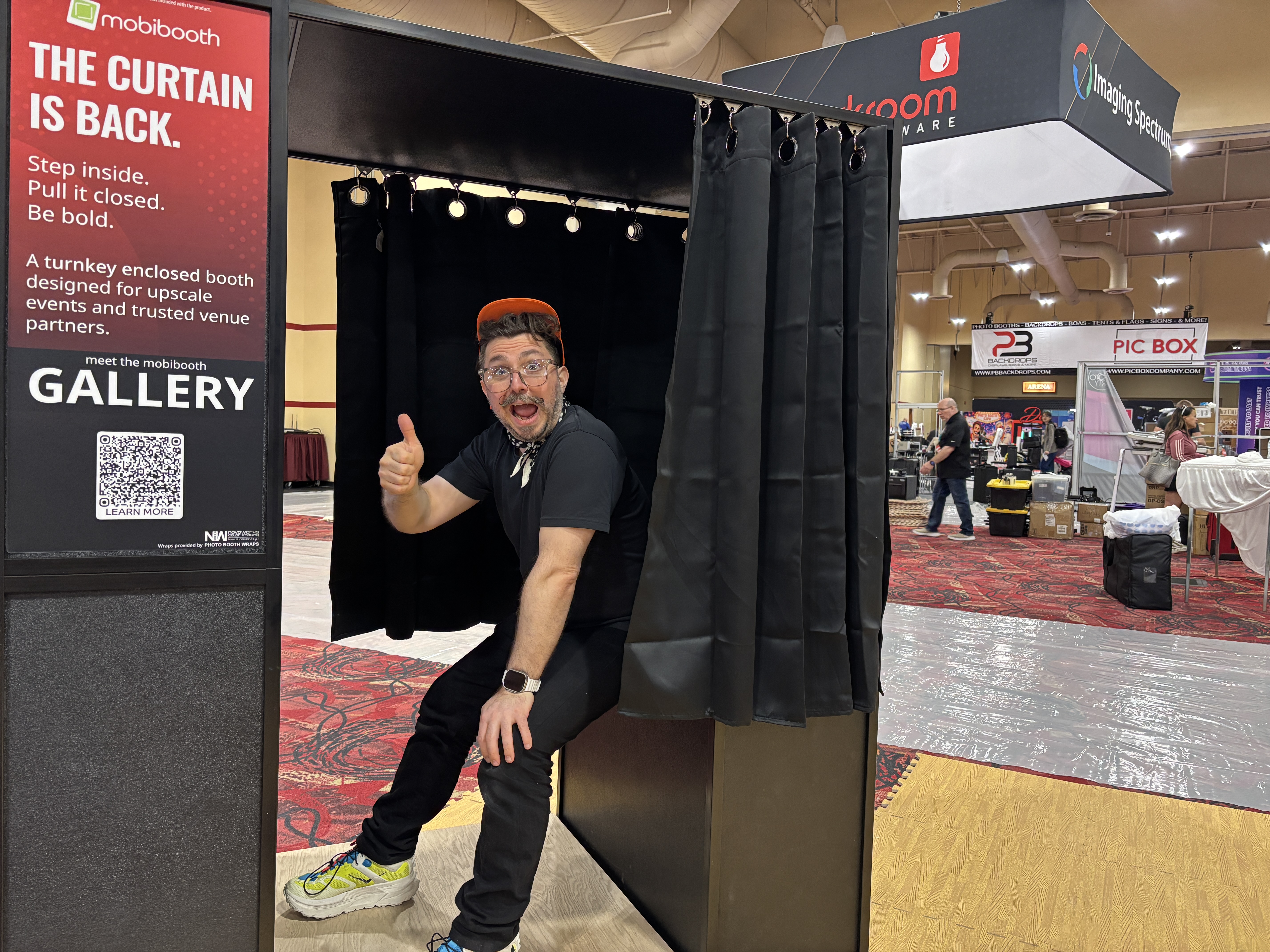 Nicholas Rhodes testing the MobiBooth Gallery enclosed photo booth at PBX 2026