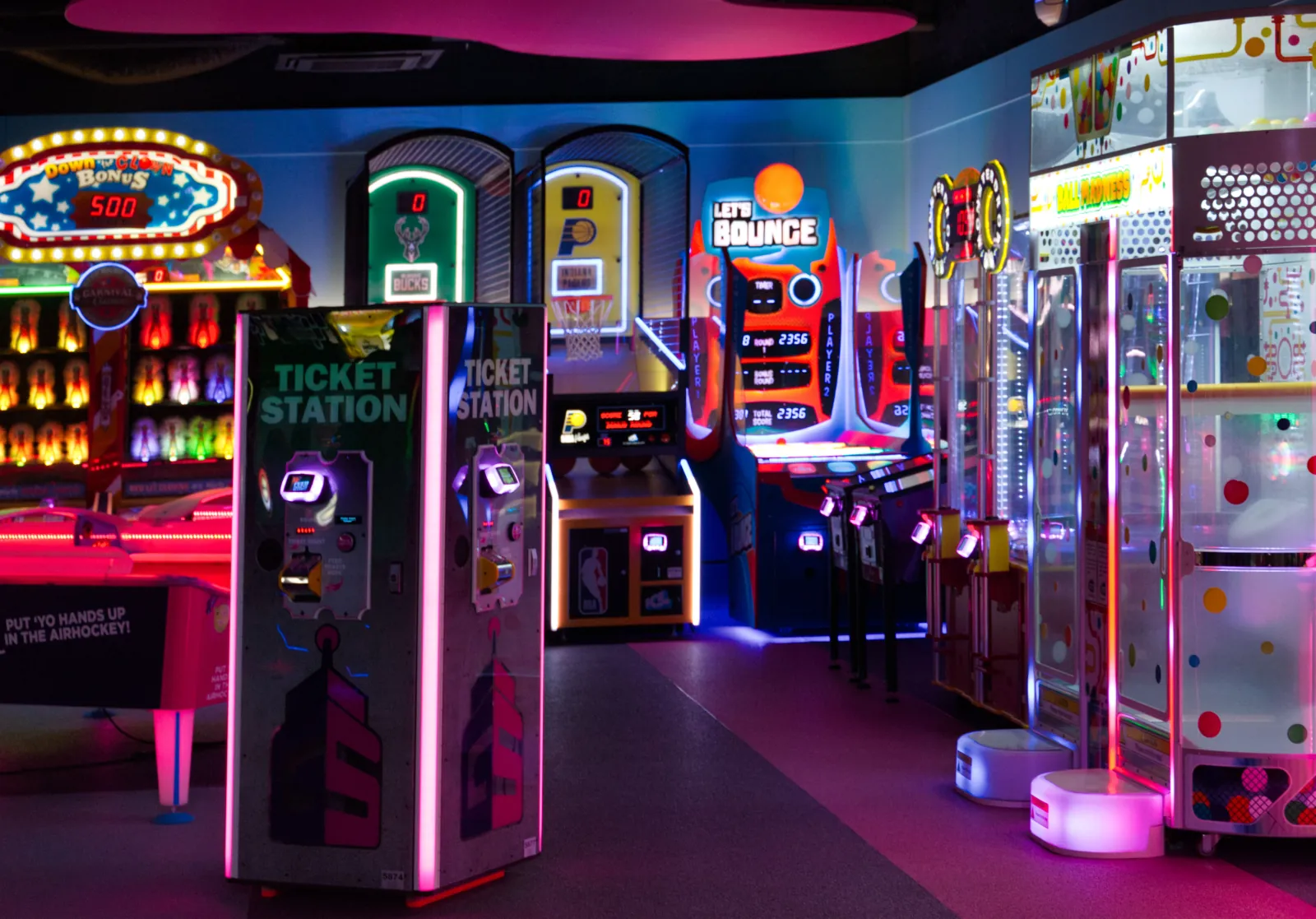 Photo Booth Software for Family Entertainment Centers 1 Neon-lit arcade games and ticket redemption machines inside a family entertainment center