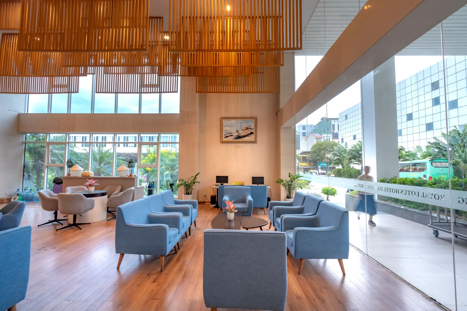 Blue armchairs and lounge seating in a bright hotel lobby