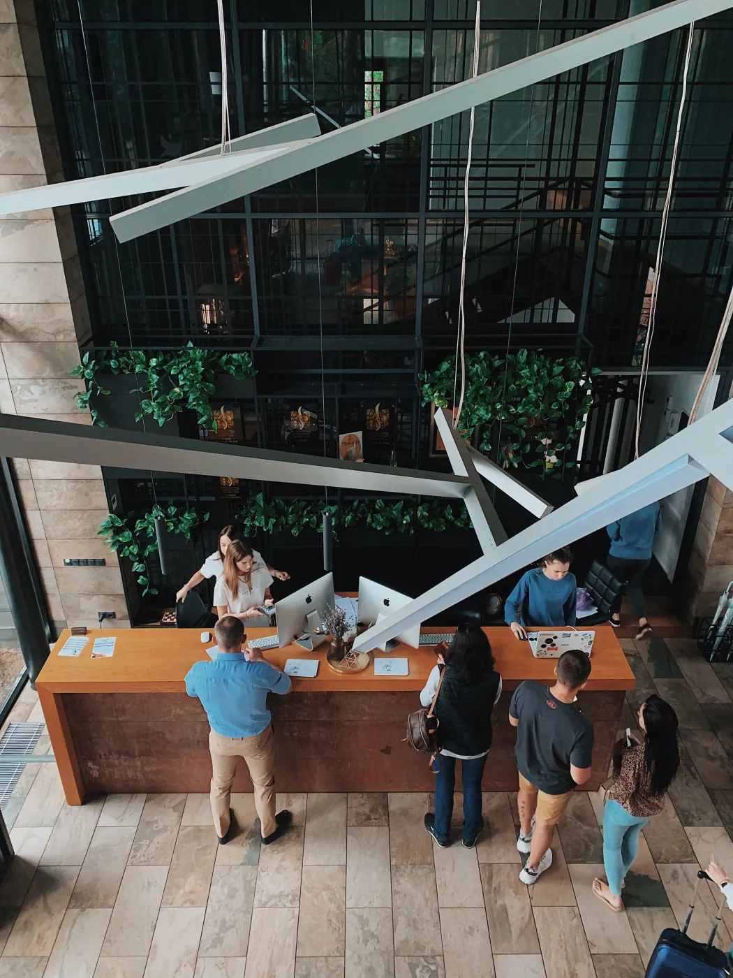 Guests checking in at a reception desk in a modern venue lobby